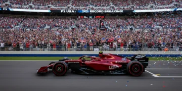 Formula 1 race car on track with cheering US crowd, symbolizing growing F1 fan engagement and viewership in America.